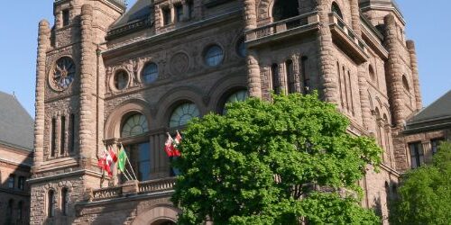 Queen's Park building with blue sky.