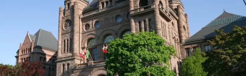 Queen's Park building with blue sky.
