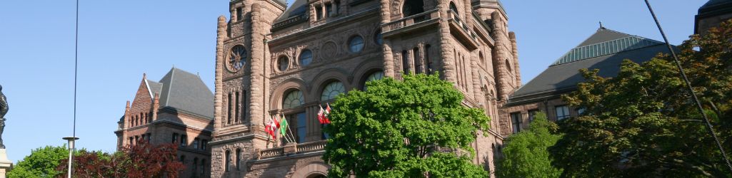 Queen's Park building with blue sky.